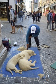 France, Seine Maritime, Rouen, street artist making a sand dog sculpture
