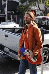 United States, California, San Francisco, formerly Hippie district of Haight-Ashbury, a man carrying his dog