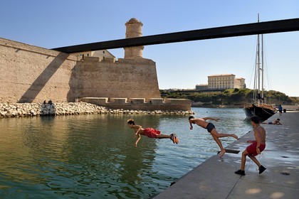 France, Bouches du Rhone, Marseille, La Joliette district, swimming area for neighborhood children at the foot of Fort Saint Jean linked to the MuCEM (Museum of Civilizations of Europe and the Mediterranean) by a bridge, Palais du Pharo in the background
