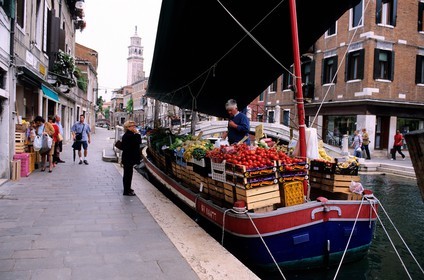 Italy, Veneto, Venice, costermonger on his boat