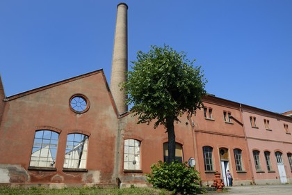 France, Haut Rhin, Mulhouse, partially deserted buildings of the DMC (Dollfus-Mieg and Company) textile company, the factory and a brick chimney