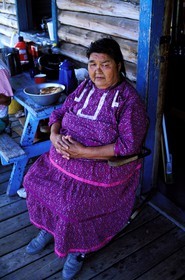 Canada, Quebec Province, La Verendrye Wildlife Reserve, Lake Victoria, village of Big Lake Victoria, Algonquian woman on her porch