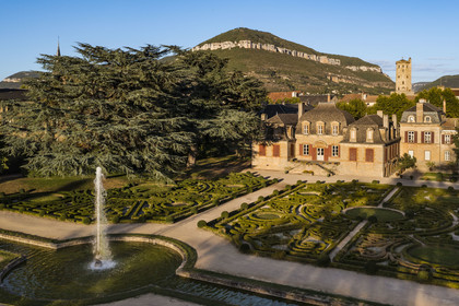 France, Aveyron, the Mansion of Sambucy De Sorgues and its French gardens, the belfry in the heart of the city and et the Puncho d'Agast mountain in the background, a 180 year old Atlas cedar (Cedrus atlantica) on the left (aerial view)