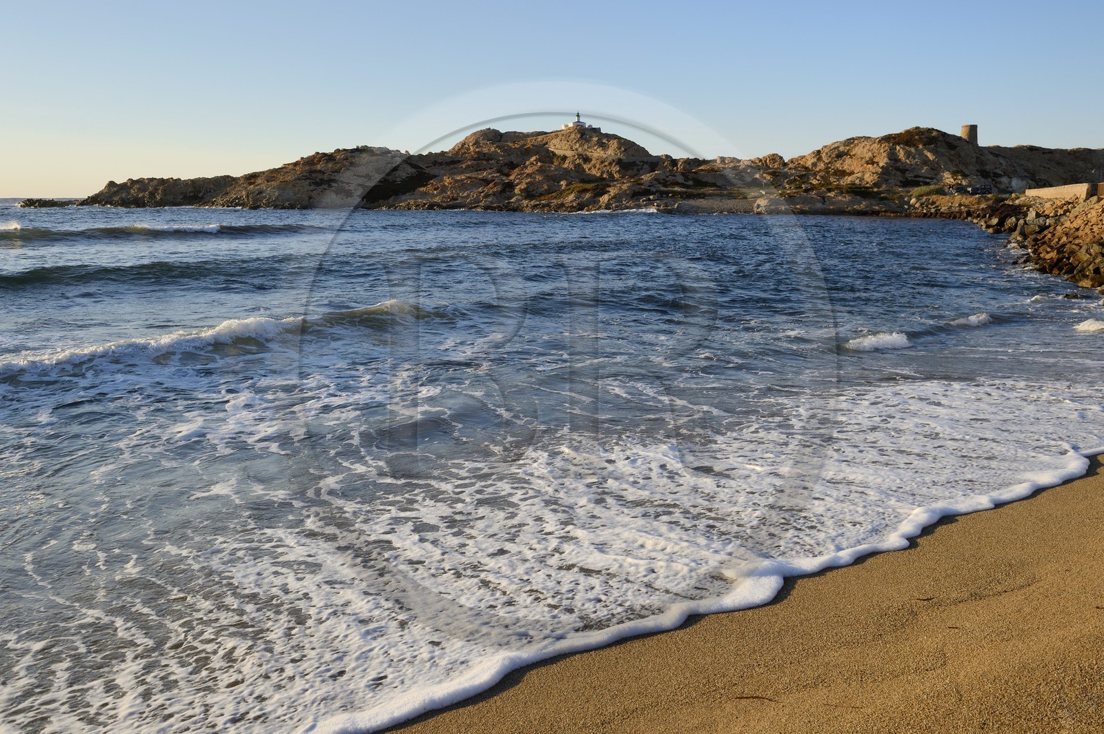 France, Haute Corse, Balagne, L'Ile Rousse, the Pietra Lighthouse and the fifteenth century Genoese tower behind the beach