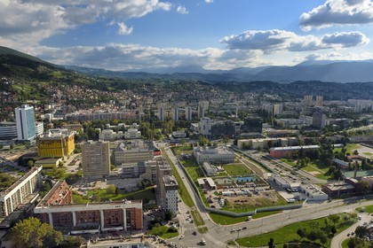 Bosnia and Herzegovina, Sarajevo, the US embassy in the center and the Sniper Alley that designated the main street of Sarajevo during the siege of Sarajevo by Serb Army Republic of Bosnia in the background from left to right