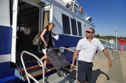 France, Var, Iles d'Hyeres, Parc National de Port Cros (National park of Port Cros), Porquerolles island, arrival of postwoman Christine Frissong at the port early morning with the mail