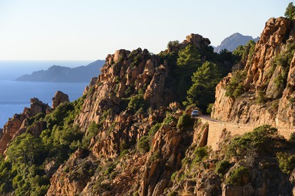 France, Corse du Sud, Golfe de Porto, listed as World Heritage by UNESCO,  the Creeks of Piana (Calanches de Piana) with pink granite rocks and the D81 road between Porto and Cargese
