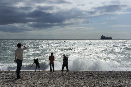 France, Seine Maritime, Le Havre, cargo leaving the port seen from the city beach