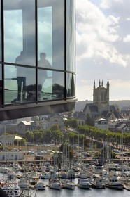France, Seine Maritime, Pays de Caux, Cote d'Albatre, Fecamp, Les Pecheries (Fishery) - Museum of Fecamp is overlooking the port and St. Stephen's Church in the background