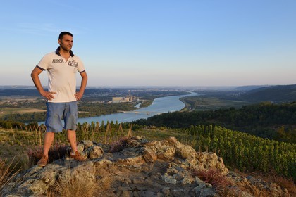 France, Loire, Parc Naturel Regional du Pilat (Natural Regional Park of Pilat), the domaine du Monteillet Stephane Montez, Stephane Montez in his vineyard overlooking the Rhone river, the Saint Alban nuclear power plant in the background