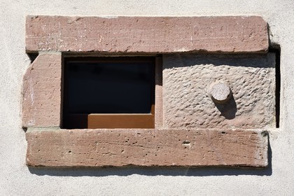 France, Bas Rhin, the Alsace Wine Route, Mittelbergheim, labelized the Most Beautiful Villages of France, flat stone used as a shutter for closing a cave window