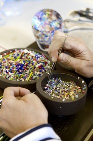 France, Moselle, Saint-Louis-les-Bitche, the Cristallerie Saint-Louis (Saint-Louis crystal glass manufacturer), preparation of a paperweight from crystal color chopsticks shaped by torch, tweezers and scissors