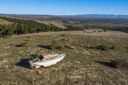 France, Hérault (34), les Causses et les Cévennes, paysage culturel de l'agro-pastoralisme méditerranéen inscrit au Patrimoine Mondial de l'UNESCO, La Vacquerie-et-Saint-Martin-de-Castries, ancien voilier échoué sur une hauteur dominant le plateau du Larzac tel l'Arche de Noé (vue aérienne)