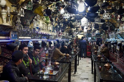 Iran, Isfahan Province, Isfahan, Chai Khaneh Azadegan Tea House and restaurant, men smoking a water pipe