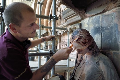 France, Bas Rhin, Strasbourg, old town listed as World Heritage by UNESCO, Notre Dame Cathedral, Judgment Day Portal Restoration Site, cleaning of the so-called Synagogue sculpture with a toothbrush by a stonemason companion