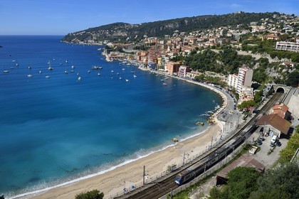 France, Alpes Maritimes, Villefranche sur Mer, the beach in the bay and the train station
