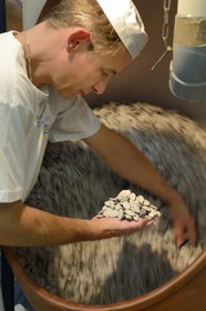 France, Meuse, Verdun, Braquier sugared almonds (dragee) factory, peeling almonds, operation designed to cover the almonds with a film and prevent oil from migrating to the outside