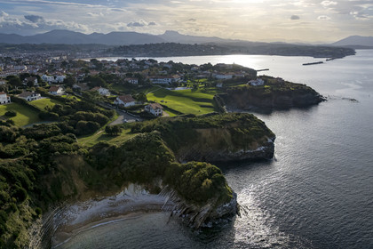 France, Pyrenees Atlantiques, Basque Country coast, Saint-Jean-de-Luz, the coastal path on the GR 8 running along the flysch cliff of the Pile d'Assiettes, a sort of mille-feuille alternating hard rocks and soft rocks, the bay of Saint-Jean-de-Luz in the background (aerial view)