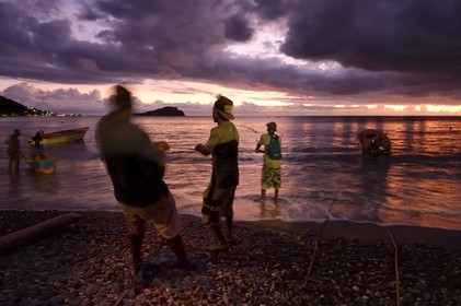 Caribbean, Dominica Island, Soufriere Bay, the village of Soufriere, beach-side net fishing at dusk