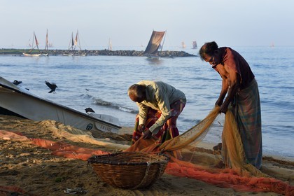 Sri Lanka, Western Province, Negombo, fishermen sorting their nets on the Porathota beach