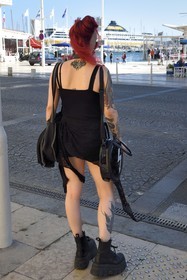 France, Var, Toulon, young tattooed woman with partially shaved and red hair gothic trend