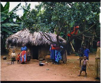 Burundi, Kirundo Province, Lake Cohoha region, Hutu peasant family posing in front of a modern hut, traditional habitat disappears in favor of square clay huts, whether or not coated with corrugated iron (4x5 reversal film reproduction)