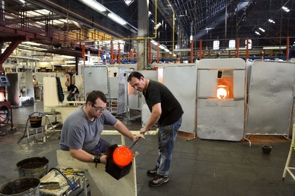 France, Moselle, Saint-Louis-les-Bitche, the Cristallerie Saint-Louis (Saint-Louis crystal glass manufacturer), shaping hot glass, glassblower using a wooden tool called mailloche to round up the crystal and make a bowl which is even