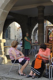 Portugal, Minho region, Guimaraes, town listed as World Heritage by UNESCO, women knitting on the square Praca de Santiago