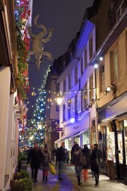 France, Bas Rhin, Strasbourg, old town listed as World Heritage by UNESCO, sign of the restaurant Le Crocodile in the Outre street and the big christmas tree on Place Kleber in the background