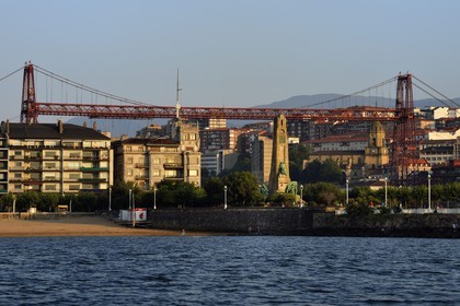 Spain, Basque Country, Biscay Province, Bilbao, Vizcaya transporter bridge (Puente de Vizcaya or Puente Colgante) on the river Nervion, listed as World Heritage by UNESCO, connecting the two cities of Portugalete and Getxo, in the foreground the monument to Evaristo de Churruca