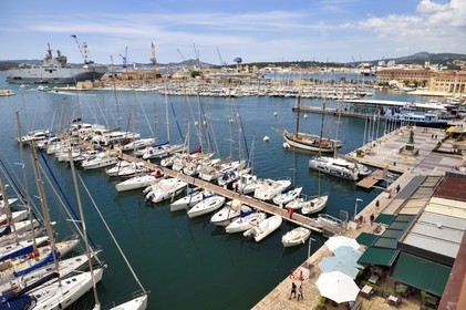France, Var, Toulon, water bus pier of the Maritime Station quay Kronstadt on the civil port, the Mistral (L9013) amphibious helicopter carrier of the French Navy in the background