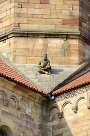 France, Bas Rhin, Rosheim village, St-Pierre and St-Paul roman Church, a seated man holding a begging bowl