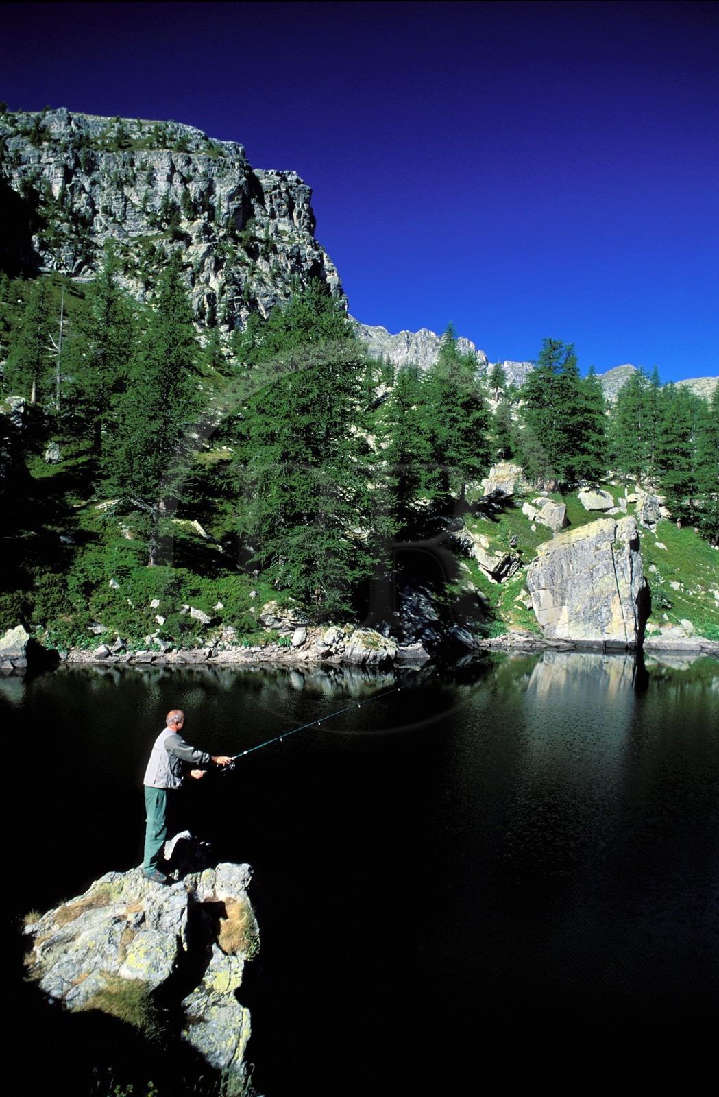 France, Alpes Maritimes, Mercantour National Park, Vallee des Merveilles near Fontanalbe, fisherman at Lake Vert