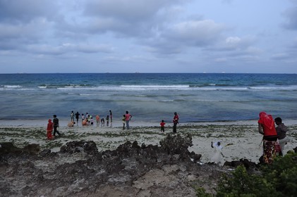 Tanzania, Dar es-Salaam, there is still lot of people at Coco Beach at dusk on Sunday