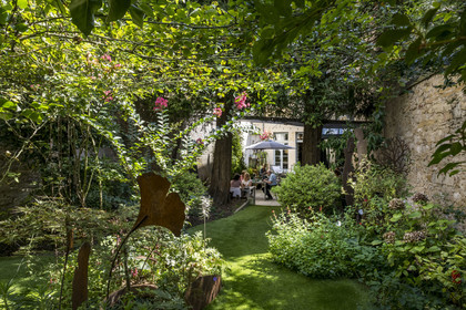 France, Cote d'Or, Dijon, area listed as World Heritage by UNESCO, Le Chat qui Pense restaurant in the former 17th-century Hotel Monge, garden side