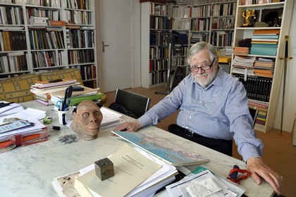 France, Paris, the french paleontologist and paleoanthropologist Yves Coppens, professor at the College de France, in the office of his home in Paris, with the supposed reproduction of Lucy's face