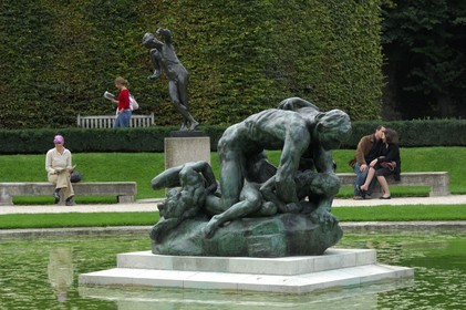 France, Paris,  the Rodin museum in the Hotel Biron,  the sculpture Ugolin and lovers kiss in the background
