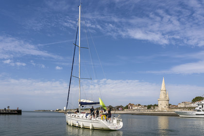 France, Charente Maritime, La Rochelle, sailboat at the Old Port entrance, the tour de la Lanterne