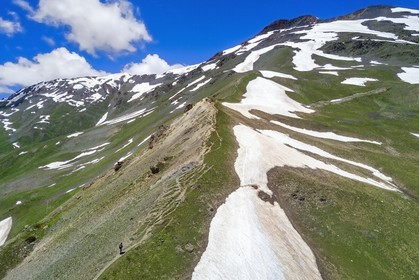 Georgia, Upper Svaneti (Zemo Svaneti), Mestia, hiker on the foothills of Mount Ushba going to Guli pass (aerial view)