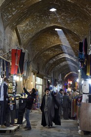 Iran, Isfahan Province, Isfahan, mullah in the Bazar-e Bozorg (Great Bazaar), a massive covered bazaar which dates back almost 1300 years, clothing store