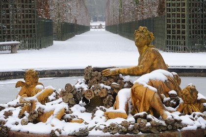 France, Yvelines, snow covered park of the Chateau de Versailles, listed as World Heritage by UNESCO, flora basin in winter also called the spring basin in Winter