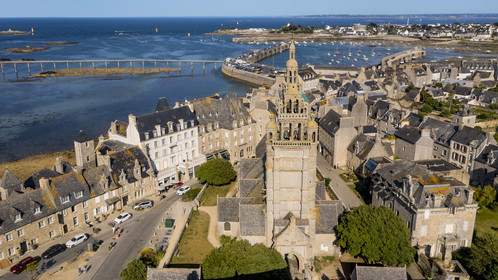 France, Finistère, Roscoff, old shipowners' houses located between rue Amiral Reveillere and the shore, on the right the Notre-Dame de Croaz Batz church and the port in the background (aerial view)