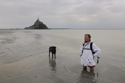 France, Manche, walking discovery of the Bay of Mont Saint Michel, the guide Romain Pilon deep in the sand