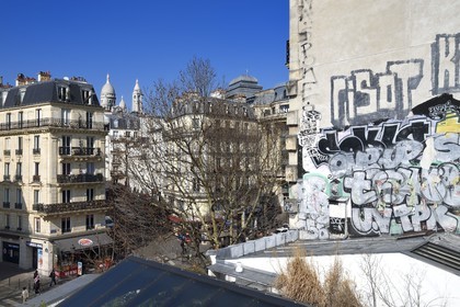 France, Paris, the Barbes district, Boulevard Barbes and the Sacre Coeur basilica in the background