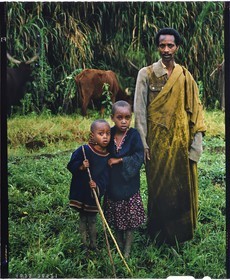 Burundi, Bujumbura Province, Ijenda area, Tutsi cattleman with two of his children, Tutsis are traditionally cattle breeders, cow is for them an almost sacred animal and represents the bulk of their wealth with the land that belonged to them until 1976, cows are used particularly in payment of the dowry, during the ceremonies it was fashionable for women to wear heavy anklets and arms in order to have the elegant cow move (4x5 reversal film reproduction)