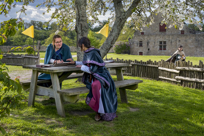 France, Vendee, Tiffauges, the castle of Tiffauges, women in medieval costumes in the old castle in ruins where Gilles de Rais resided