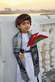 Sultanate of Oman, Ash Sharqiyah South Governorate, city and harbour of Sur, the old fishing quarter of Al Ayjah, Jassin, young Omani in traditional dress on the occasion of the national holiday of November 18