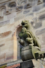 France, Bas Rhin, Rosheim village, St-Pierre and St-Paul roman Church, the lustful sculpture acroterion symbolizes sin, a lavishly dressed man appears crushed by a threatening lion
