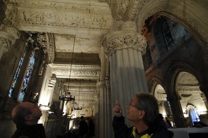 United Kingdom, Scotland, Midlothian, Roslin, Rosslyn Chapel, visitors dissecting the symbolism of the sculptures