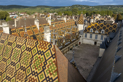 France, Cote d'Or, Beaune, area listed as World Heritage by UNESCO, Hospices de Beaune, Hotel Dieu courtyard of honor, the Côte de Beaune in the background (aerial view)